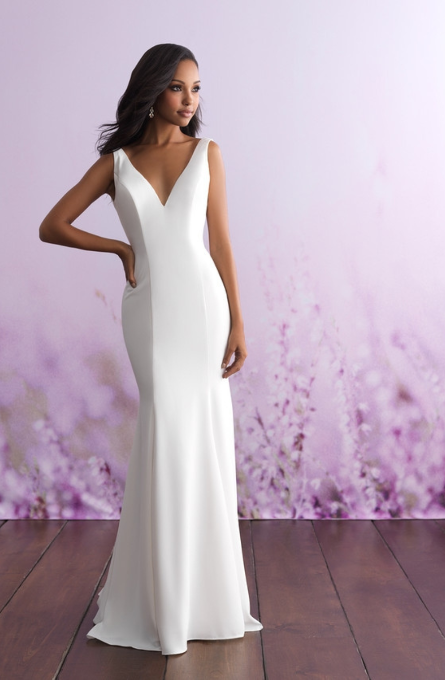 model is wearing a sleeveless sheath wedding dress