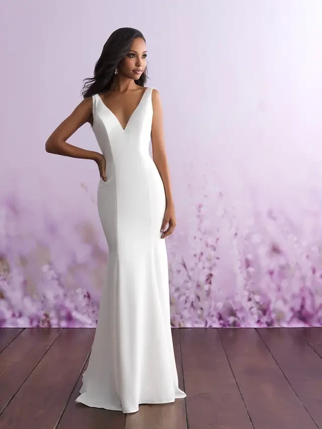 model is wearing a sleeveless open back sheath bridal gown