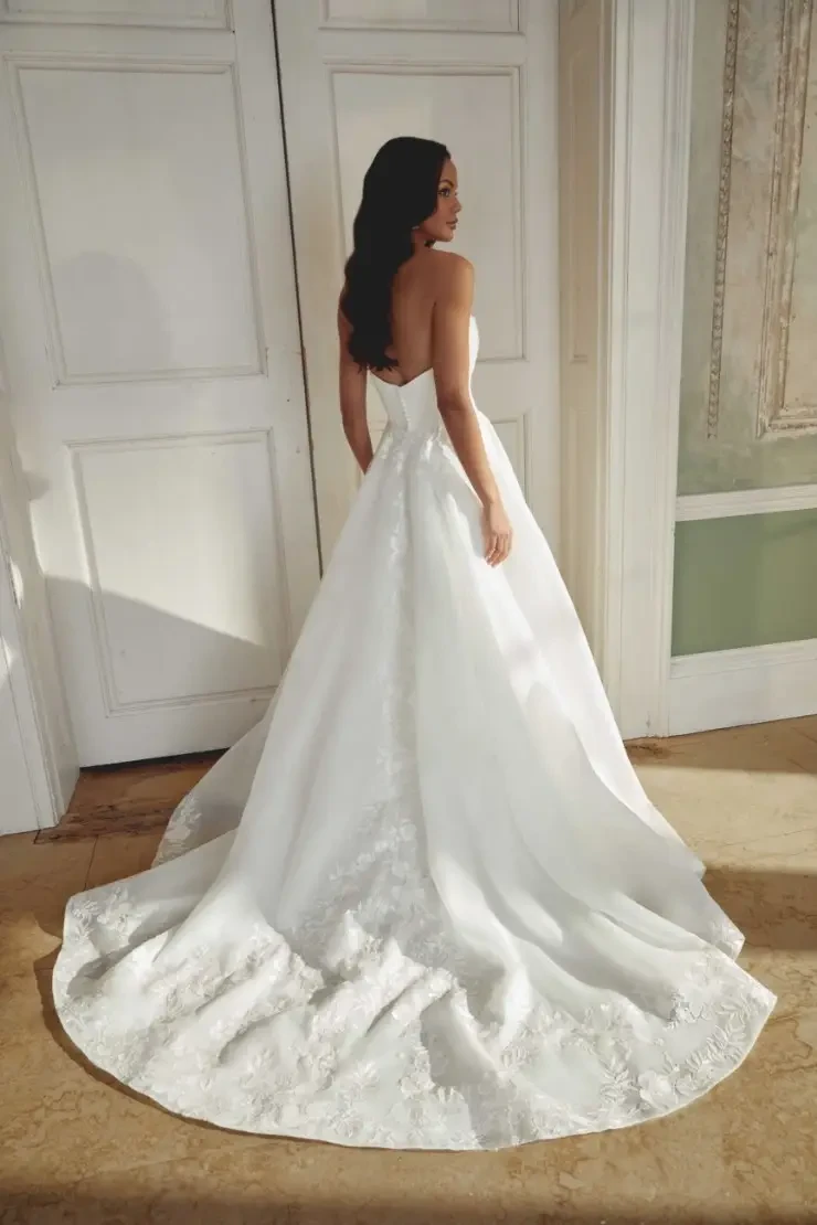 model is wearing a strapless ball gown wedding dress