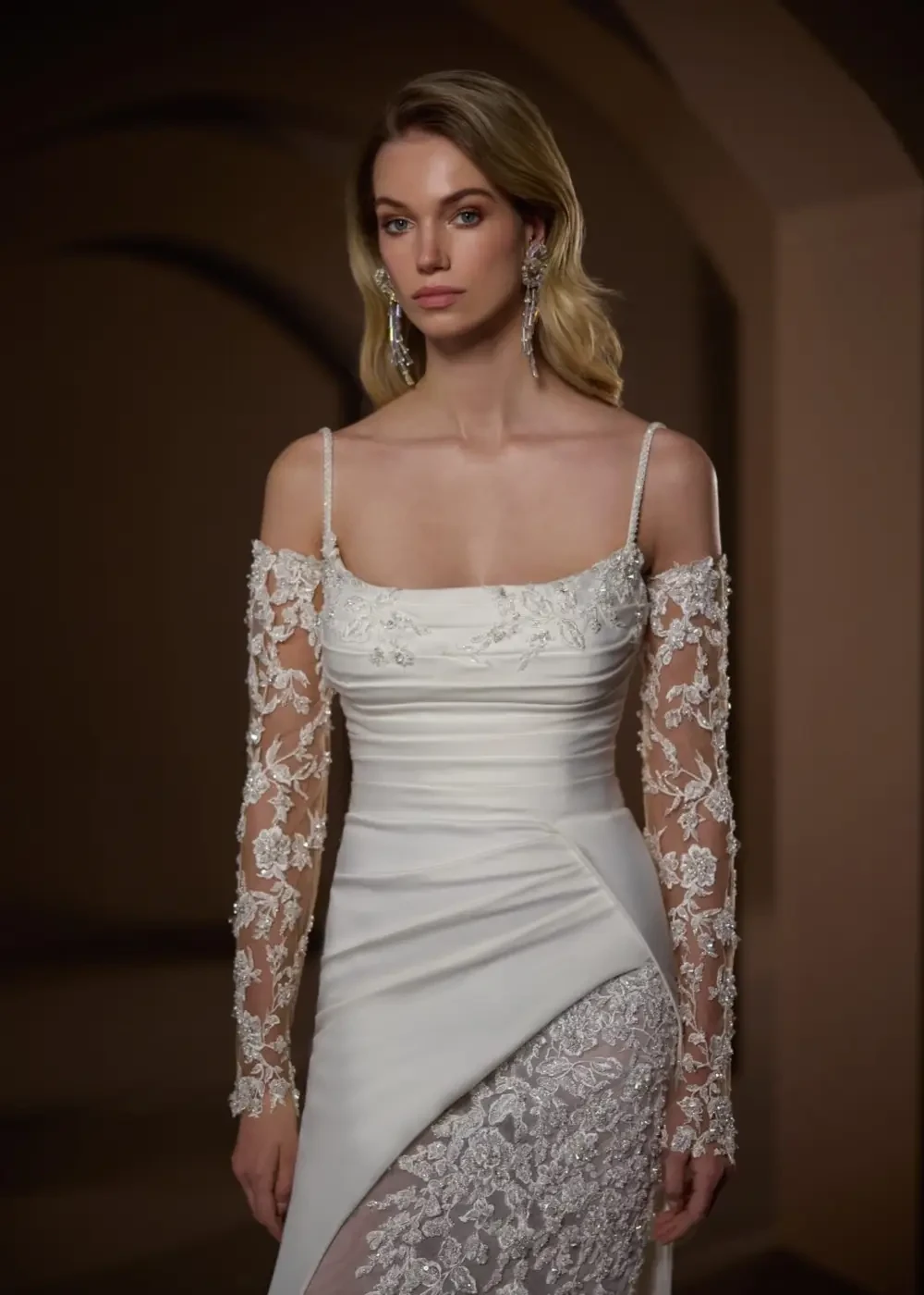 model is wearing a lace off the shoulder bridal gown