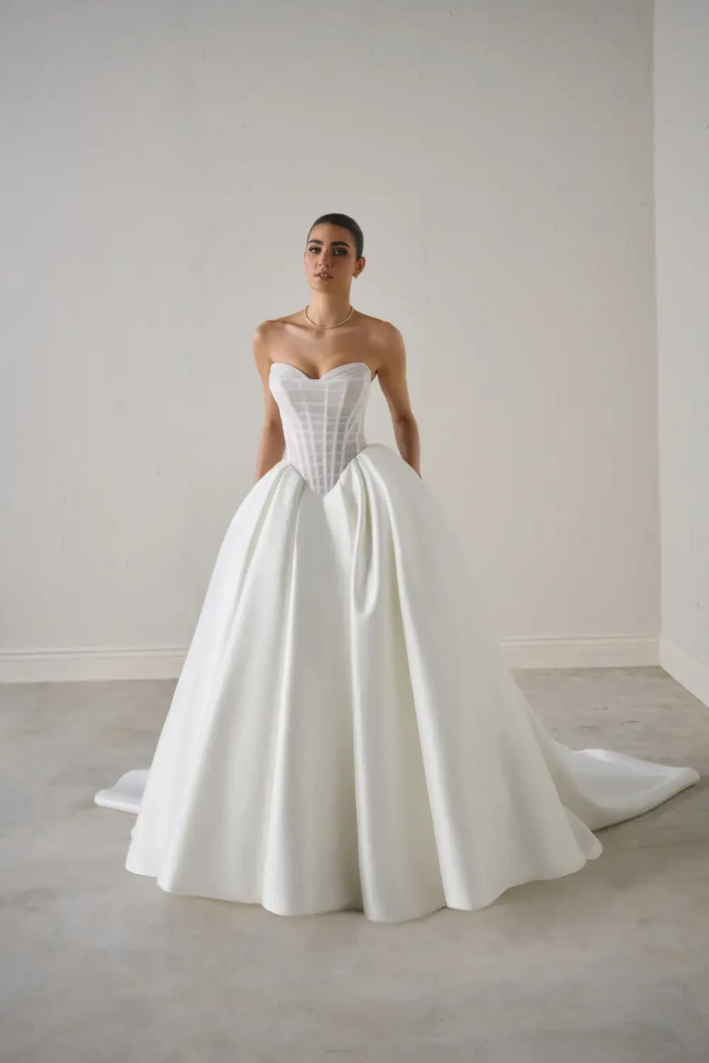 model is wearing a basque waist bridal gown