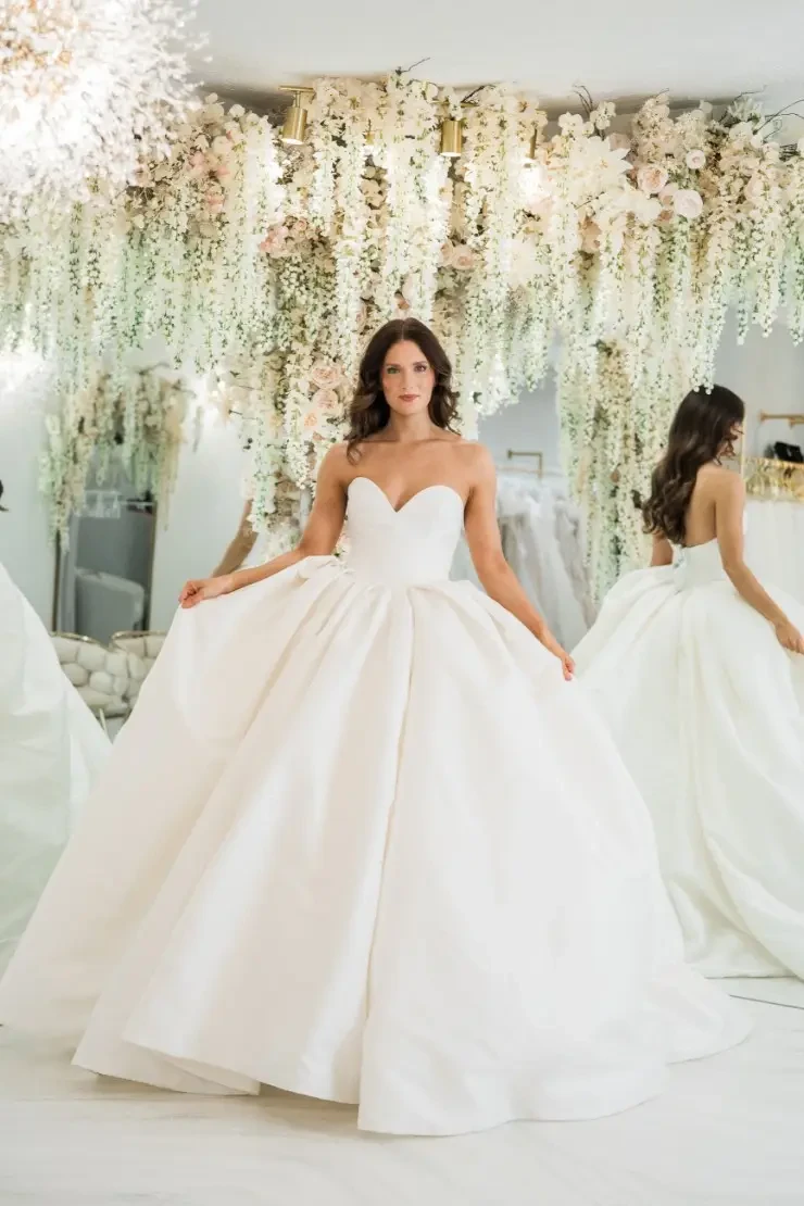 model is wearing a strapless ball gown wedding dress