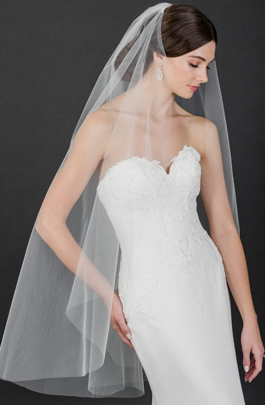 model is wearing a fingertip length bridal veil