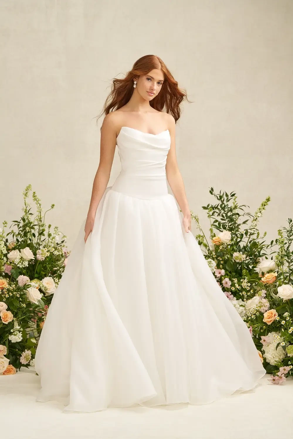 model is wearing a strapless drop waist bridal gown