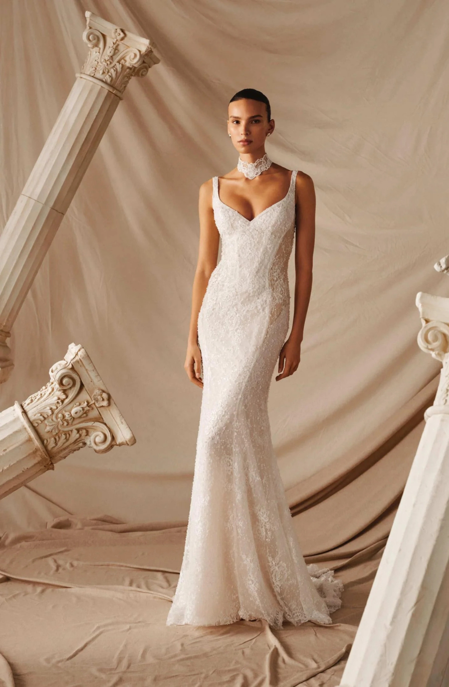 model is wearing a sleeveless bridal gown