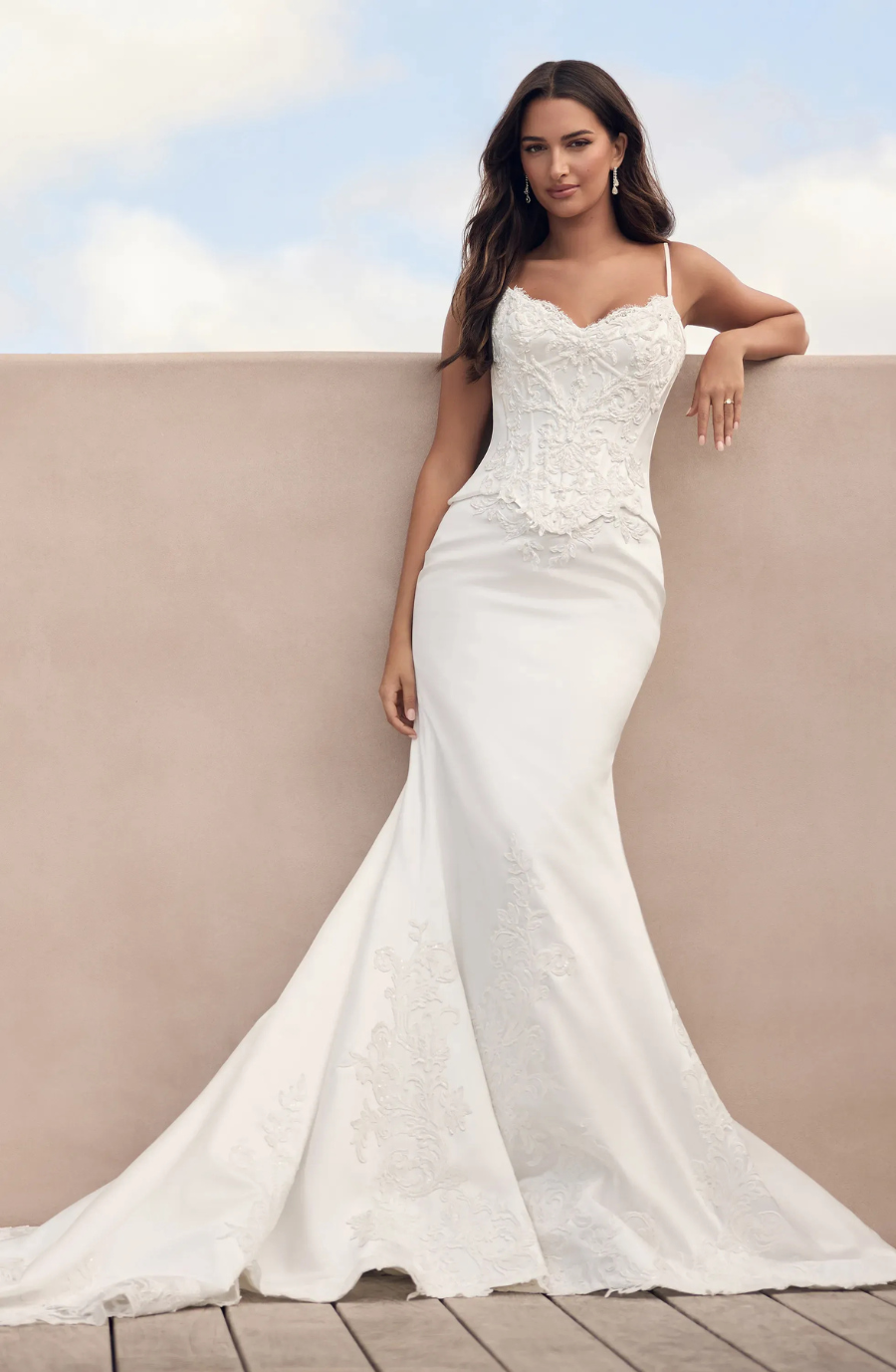 model is wearing a sleek fit and flare bridal gown